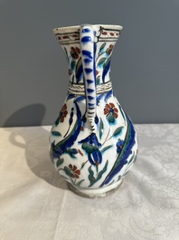 A polychrome and gilt Iznik ewer with tulips, carnation flowers and saz leaves, Turkey, ca. 1600