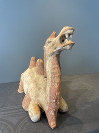 A pair of Chinese polychrome-painted terracotta camels with saddles, Tang