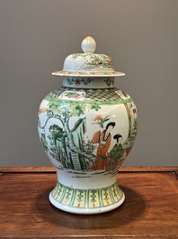 A Chinese famille verte covered vase and a bottle vase, 19th C.