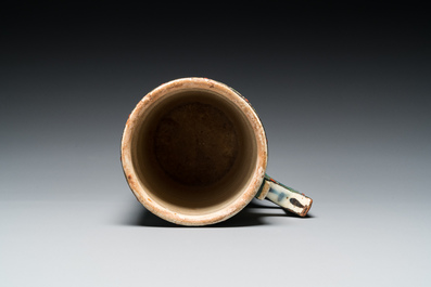 A polychrome Iznik-style mug with tulips and carnations, Kutahya, Turkey, 19th C.
