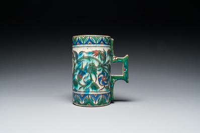 A polychrome Iznik-style mug with tulips and carnations, Kutahya, Turkey, 19th C.