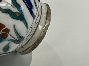 A polychrome and gilt Iznik ewer with tulips, carnation flowers and saz leaves, Turkey, ca. 1600