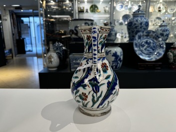 A polychrome and gilt Iznik ewer with tulips, carnation flowers and saz leaves, Turkey, ca. 1600
