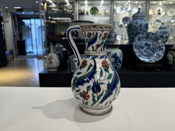 A polychrome and gilt Iznik ewer with tulips, carnation flowers and saz leaves, Turkey, ca. 1600