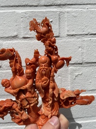 A Chinese red coral group of Shoulao with two boys holding a peach, inscribed 'Shou Bi Nan Shan 壽比南山', 19/20th C.