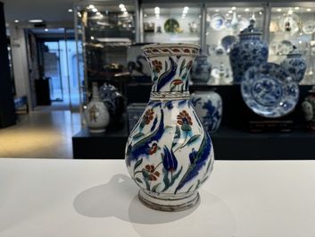 A polychrome and gilt Iznik ewer with tulips, carnation flowers and saz leaves, Turkey, ca. 1600