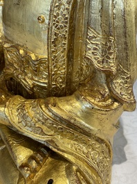 A large Sino-Tibetan gilt bronze Buddha on wooden stand, Ming