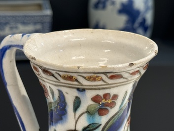 A polychrome and gilt Iznik ewer with tulips, carnation flowers and saz leaves, Turkey, ca. 1600