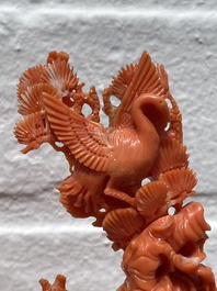 A Chinese red coral group of Shoulao with two boys holding a peach, inscribed 'Shou Bi Nan Shan 壽比南山', 19/20th C.