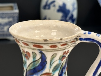 A polychrome and gilt Iznik ewer with tulips, carnation flowers and saz leaves, Turkey, ca. 1600