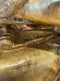 A large Sino-Tibetan gilt bronze Buddha on wooden stand, Ming