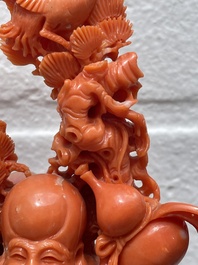 A Chinese red coral group of Shoulao with two boys holding a peach, inscribed 'Shou Bi Nan Shan 壽比南山', 19/20th C.