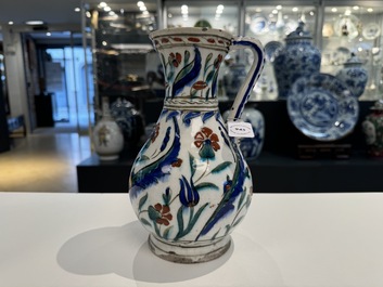 A polychrome and gilt Iznik ewer with tulips, carnation flowers and saz leaves, Turkey, ca. 1600