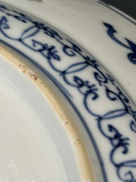 A pair of Chinese blue and white plates with floral design and reticulated border, conical shell mark, Kangxi