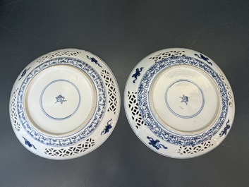 A pair of Chinese blue and white plates with floral design and reticulated border, conical shell mark, Kangxi