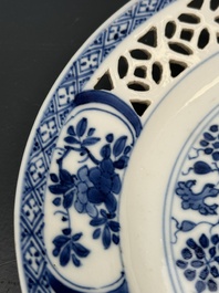 A pair of Chinese blue and white plates with floral design and reticulated border, conical shell mark, Kangxi