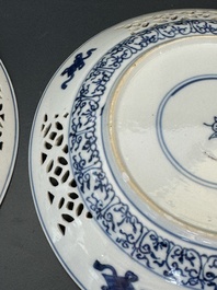 A pair of Chinese blue and white plates with floral design and reticulated border, conical shell mark, Kangxi