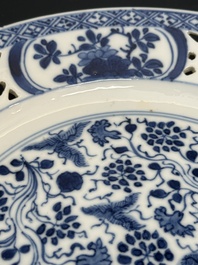A pair of Chinese blue and white plates with floral design and reticulated border, conical shell mark, Kangxi