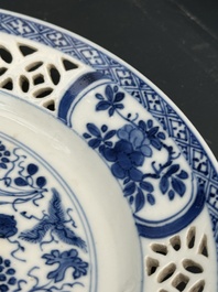 A pair of Chinese blue and white plates with floral design and reticulated border, conical shell mark, Kangxi