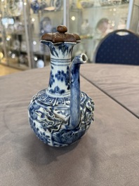 A fine Chinese blue and white 'pomegranate' kendi and a wooden cover, Wanli