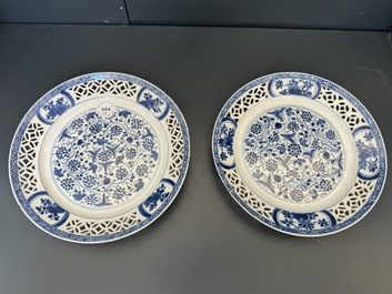A pair of Chinese blue and white plates with floral design and reticulated border, conical shell mark, Kangxi