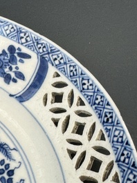 A pair of Chinese blue and white plates with floral design and reticulated border, conical shell mark, Kangxi