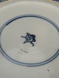 A pair of Chinese blue and white plates with floral design and reticulated border, conical shell mark, Kangxi