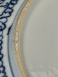A pair of Chinese blue and white plates with floral design and reticulated border, conical shell mark, Kangxi