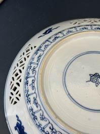 A pair of Chinese blue and white plates with floral design and reticulated border, conical shell mark, Kangxi