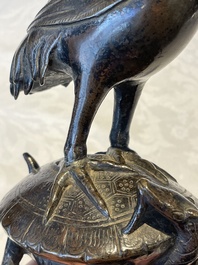 A Chinese bronze candle or incense holder in the shape of a crane standing on a turtle and a Tibetan vajra, Ming/Qing