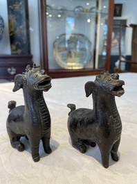 A pair of Chinese bronze mythical creatures and two ewers, Ming