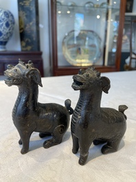 A pair of Chinese bronze mythical creatures and two ewers, Ming