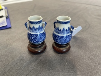 A pair of Chinese blue and white miniature 'hu' vases on wooden stands, Kangxi mark, 19th C.