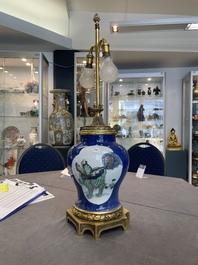 A Chinese famille verte  powder-blue-ground 'mythical animal' vase with gilt bronze lamp mounts, 19th C.