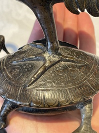 A Chinese bronze candle or incense holder in the shape of a crane standing on a turtle and a Tibetan vajra, Ming/Qing