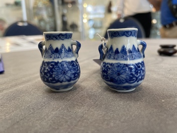 A pair of Chinese blue and white miniature 'hu' vases on wooden stands, Kangxi mark, 19th C.