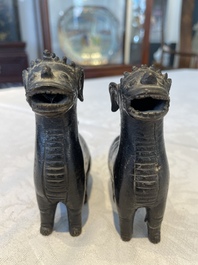 A pair of Chinese bronze mythical creatures and two ewers, Ming