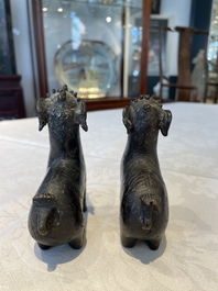 A pair of Chinese bronze mythical creatures and two ewers, Ming