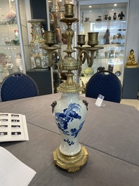 A pair of Chinese blue and white Nanking crackle-glazed vases with gilt bronze candelabra mounts, 19th C.