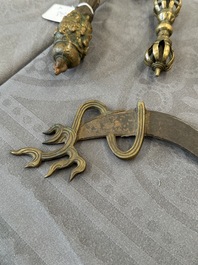A varied collection of Tibetan bronze, iron and copper alloy ritual instruments, 14th C. and later