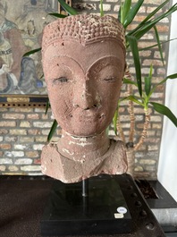 A Thai red sandstone head of Buddha, possibly Ayutthaya period, 15th C.