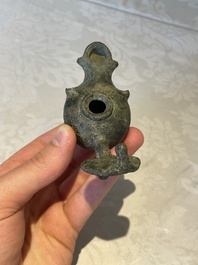 A bronze urn, a bronze canteen with relief design and a pair of bronze oil lamps, Roman Empire, 9th C. B.C/5th C.