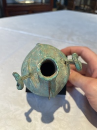 A bronze urn, a bronze canteen with relief design and a pair of bronze oil lamps, Roman Empire, 9th C. B.C/5th C.