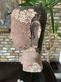 A Thai red sandstone head of Buddha, possibly Ayutthaya period, 15th C.