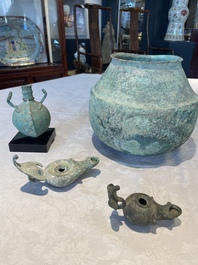 A bronze urn, a bronze canteen with relief design and a pair of bronze oil lamps, Roman Empire, 9th C. B.C/5th C.
