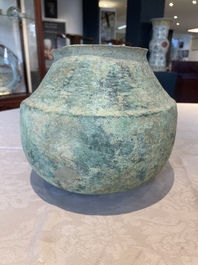 A bronze urn, a bronze canteen with relief design and a pair of bronze oil lamps, Roman Empire, 9th C. B.C/5th C.
