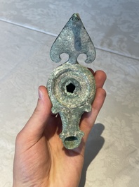A bronze urn, a bronze canteen with relief design and a pair of bronze oil lamps, Roman Empire, 9th C. B.C/5th C.