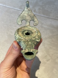 A bronze urn, a bronze canteen with relief design and a pair of bronze oil lamps, Roman Empire, 9th C. B.C/5th C.