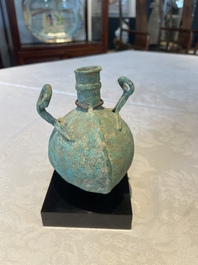 A bronze urn, a bronze canteen with relief design and a pair of bronze oil lamps, Roman Empire, 9th C. B.C/5th C.