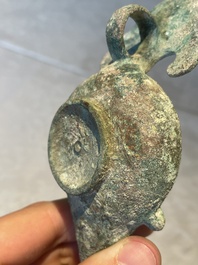 A bronze urn, a bronze canteen with relief design and a pair of bronze oil lamps, Roman Empire, 9th C. B.C/5th C.